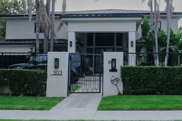 Modern front entrance with clipped hedges and a stone path