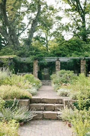 Walled garden with stone pillars and layered planting
