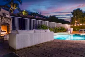 Pool terrace with lounge seating at dusk