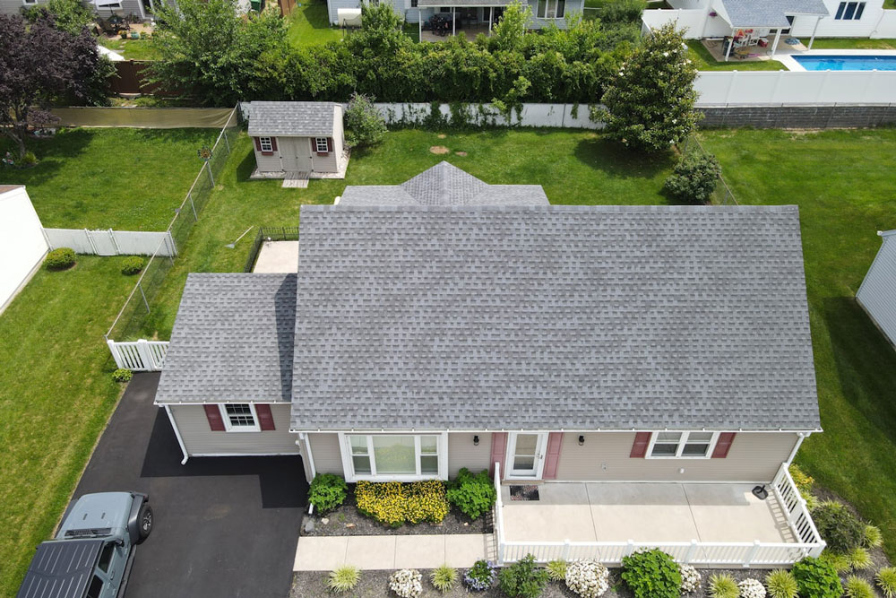 Aerial view of a two-storey Avon Lake home with a new charcoal shingle roof